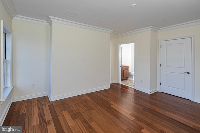 unfurnished room featuring baseboards, wood finished floors, and ornamental molding