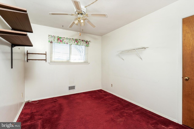 spare room with baseboards, carpet flooring, visible vents, and a ceiling fan