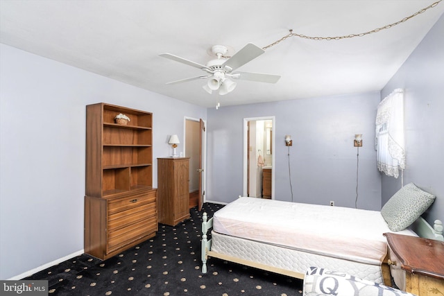 bedroom featuring a ceiling fan, carpet floors, ensuite bath, and baseboards