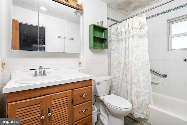 full bathroom with toilet, vanity, tile walls, and shower / bath combo