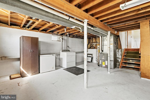 unfinished basement featuring stairs, heating unit, independent washer and dryer, and refrigerator
