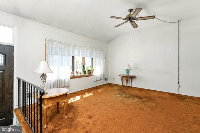 sitting room featuring lofted ceiling, carpet, and a ceiling fan