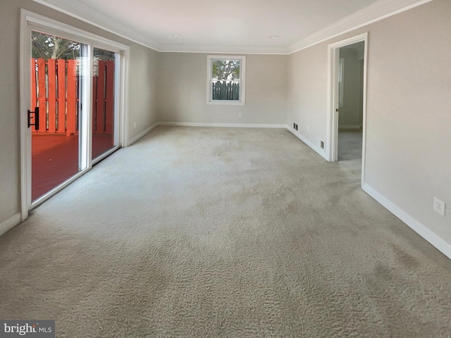 unfurnished room featuring baseboards, crown molding, and carpet floors