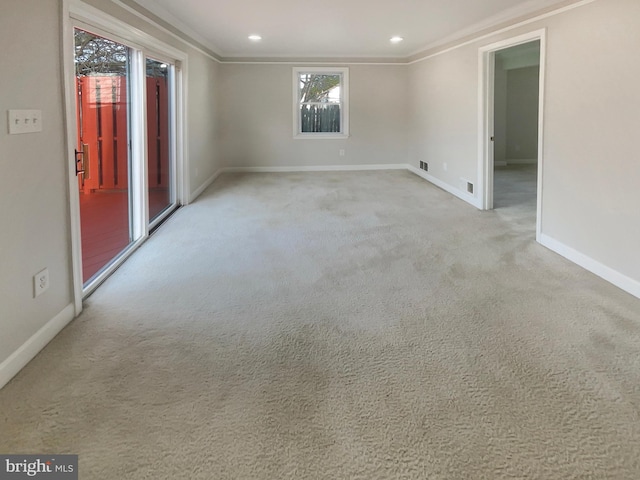 carpeted spare room with baseboards, recessed lighting, and crown molding