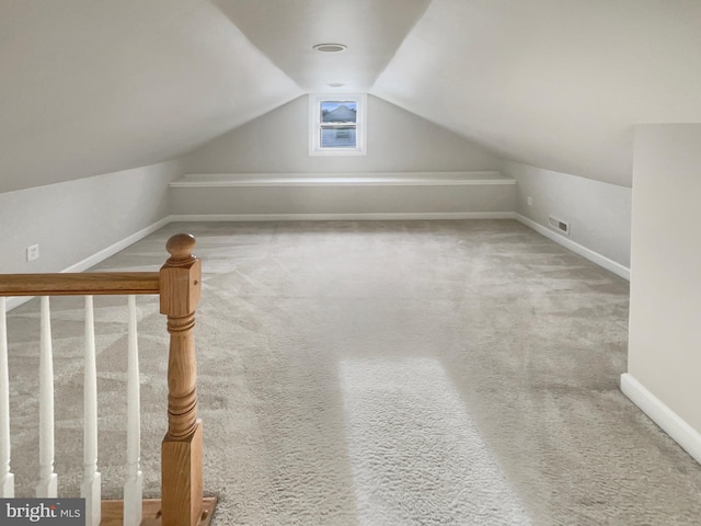 bonus room with baseboards, visible vents, lofted ceiling, and carpet