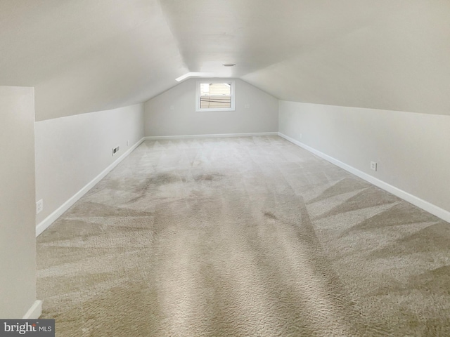 bonus room with baseboards, carpet floors, and vaulted ceiling