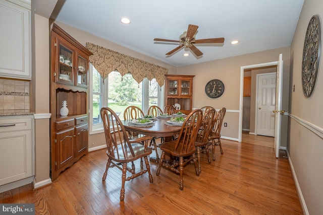 dining space with light wood-style floors, baseboards, a ceiling fan, and recessed lighting