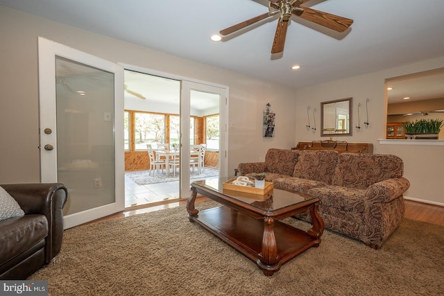 living area featuring baseboards, ceiling fan, recessed lighting, and wood finished floors