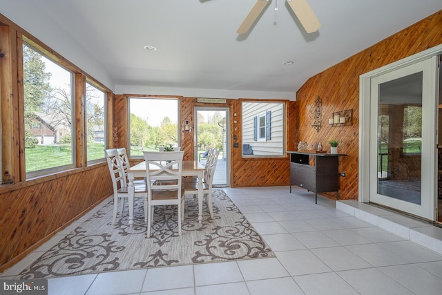 sunroom / solarium featuring wooden walls and tile patterned floors