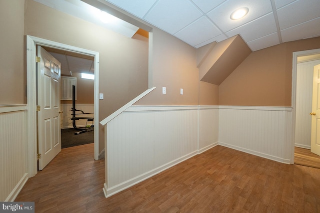 additional living space with wainscoting and wood finished floors