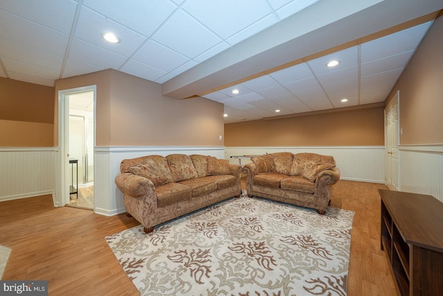 living area featuring recessed lighting, wainscoting, and wood finished floors