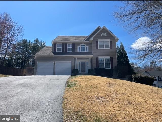 63 Woodleigh Ln, Stafford, VA 22556 - traditional-style home with aphalt driveway and a front yard