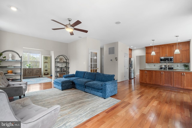 63 Woodleigh Ln, Stafford, VA 22556 - living room with visible vents, light wood-style flooring, and a ceiling fan