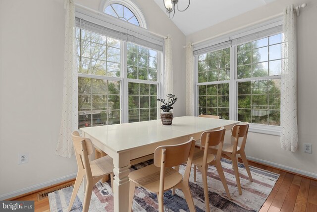63 Woodleigh Ln, Stafford, VA 22556 - dining room with baseboards, visible vents, wood finished floors, and vaulted ceiling