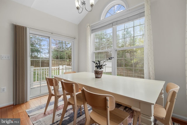 63 Woodleigh Ln, Stafford, VA 22556 - dining space with baseboards, vaulted ceiling, a notable chandelier, and light wood-type flooring