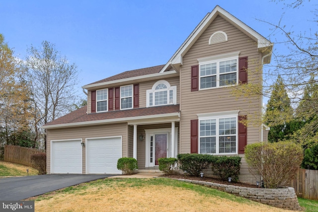 63 Woodleigh Ln, Stafford, VA 22556 - traditional-style house with driveway, fence, and a front lawn