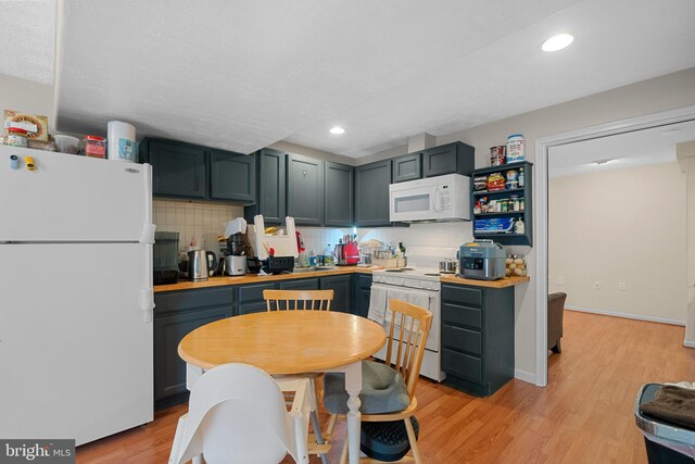 63 Woodleigh Ln, Stafford, VA 22556 - kitchen with recessed lighting, tasteful backsplash, light wood-style floors, and white appliances