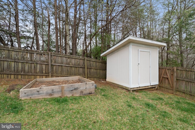 63 Woodleigh Ln, Stafford, VA 22556 - view of yard featuring an outdoor structure, a fenced backyard, a storage unit, and a garden