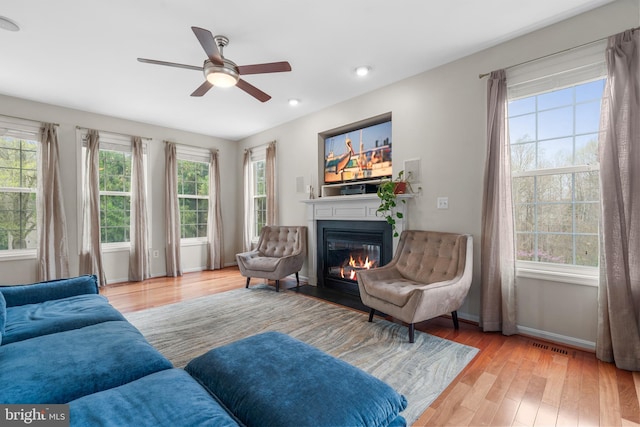 63 Woodleigh Ln, Stafford, VA 22556 - living area featuring a ceiling fan, wood finished floors, a glass covered fireplace, baseboards, and recessed lighting