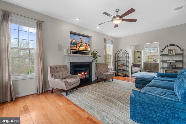 63 Woodleigh Ln, Stafford, VA 22556 - living room featuring plenty of natural light, a fireplace with flush hearth, light wood finished floors, and ceiling fan