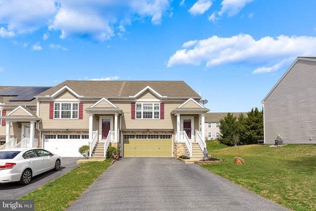 521 Fox Ridge Ln, Lebanon, PA 17042 - split foyer home with a garage, asphalt driveway, stone siding, a front yard, and stairs