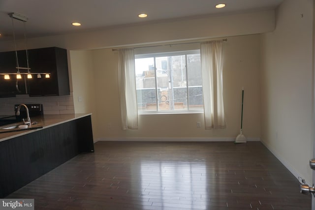 1131 S 20th St, Philadelphia, PA 19146 - interior space featuring decorative backsplash, dark wood-style flooring, baseboards, recessed lighting, and a sink