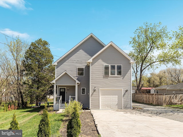 traditional-style home featuring a front yard, an attached garage, fence, and driveway