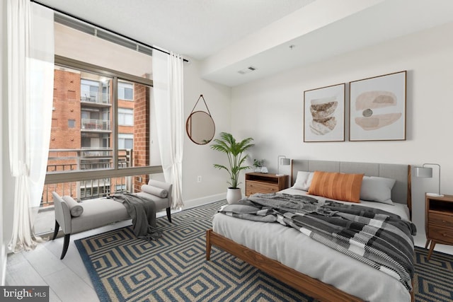 bedroom featuring baseboards and visible vents