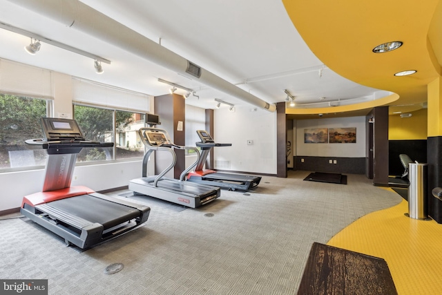 gym featuring carpet floors and track lighting
