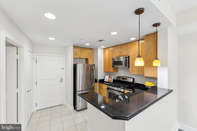 kitchen with visible vents, dark countertops, appliances with stainless steel finishes, and a peninsula