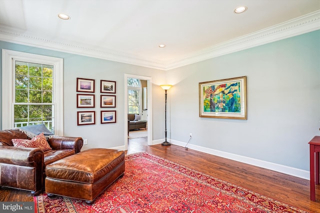 living area featuring baseboards, recessed lighting, ornamental molding, and dark wood-style flooring