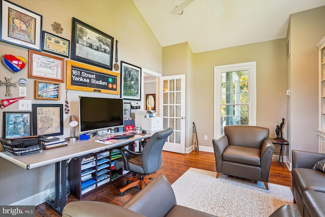 office space featuring high vaulted ceiling, wood finished floors, and baseboards