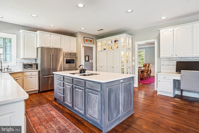 kitchen with white cabinetry, dark wood-style floors, stainless steel appliances, and gray cabinetry