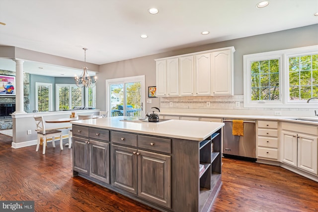 kitchen with plenty of natural light, stainless steel dishwasher, recessed lighting, and decorative columns
