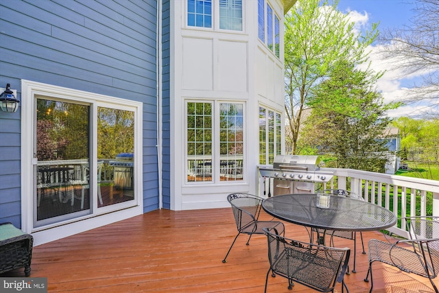 wooden deck featuring outdoor dining space