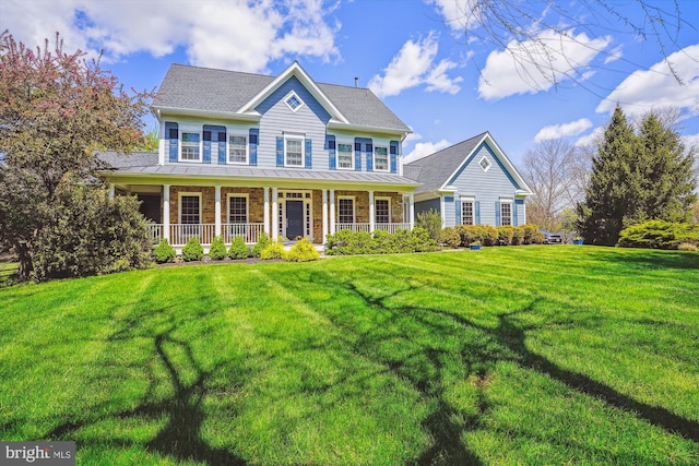 colonial inspired home with covered porch and a front yard