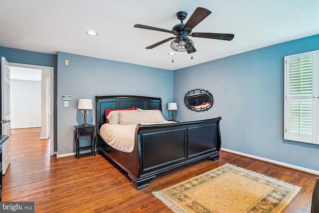 bedroom with baseboards, wood finished floors, recessed lighting, and ceiling fan