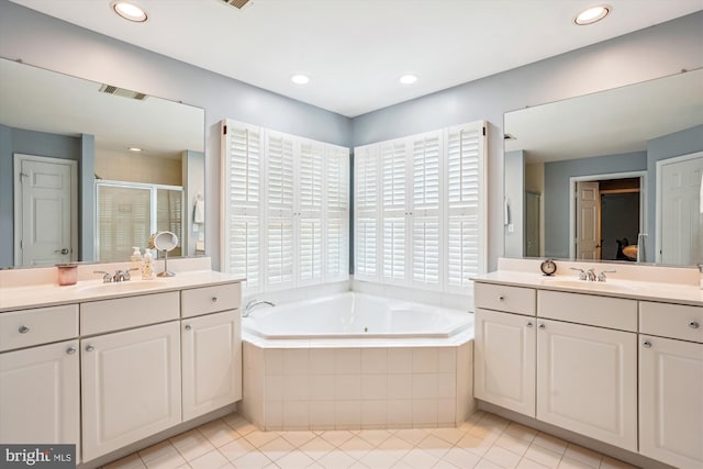 bathroom with a shower stall, tile patterned floors, visible vents, a sink, and a garden tub