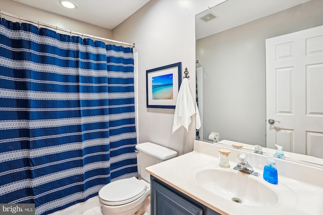 bathroom featuring toilet, vanity, curtained shower, and visible vents