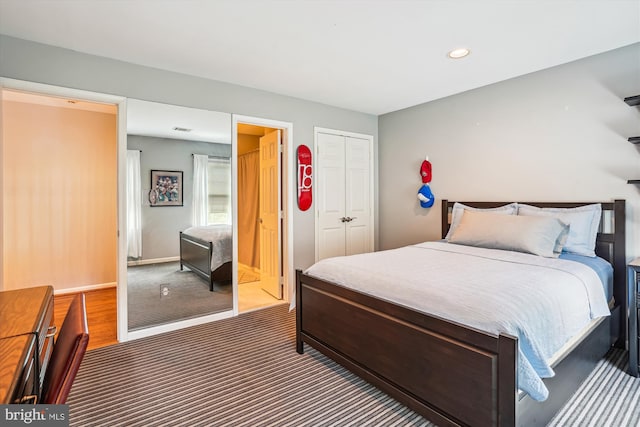 carpeted bedroom featuring recessed lighting, a closet, visible vents, and baseboards