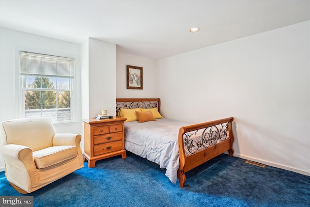 carpeted bedroom featuring baseboards and recessed lighting