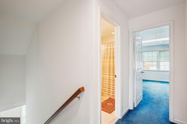 hallway featuring recessed lighting, baseboards, carpet floors, and an upstairs landing