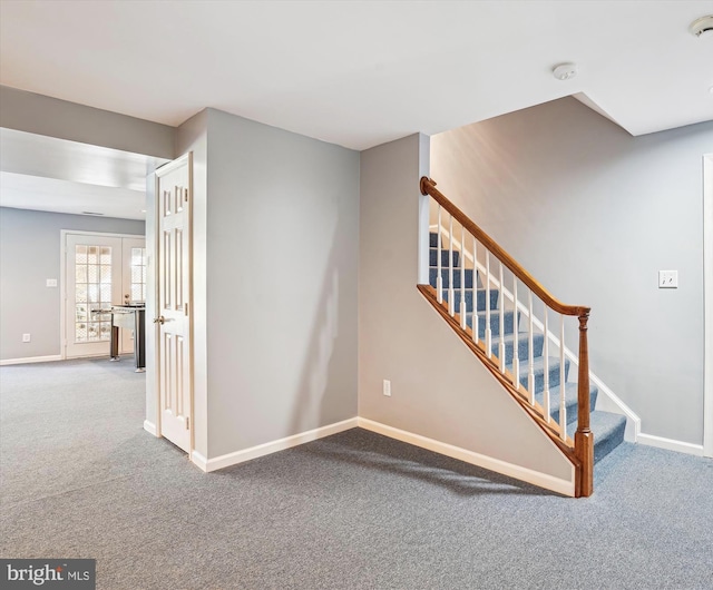 stairway with baseboards, french doors, and carpet
