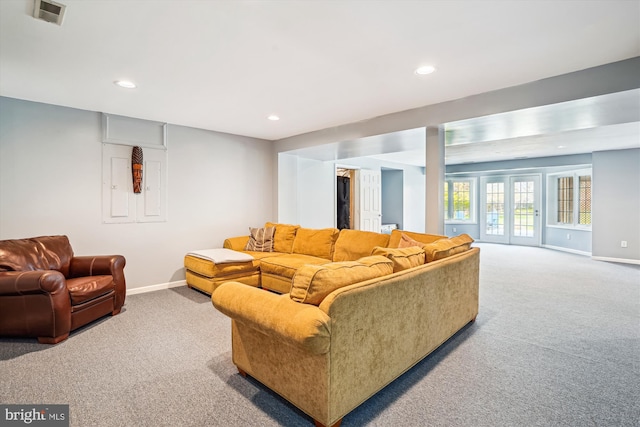 living room with baseboards, visible vents, and carpet floors