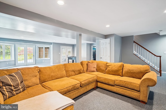 carpeted living area featuring stairway, baseboards, a wealth of natural light, and recessed lighting