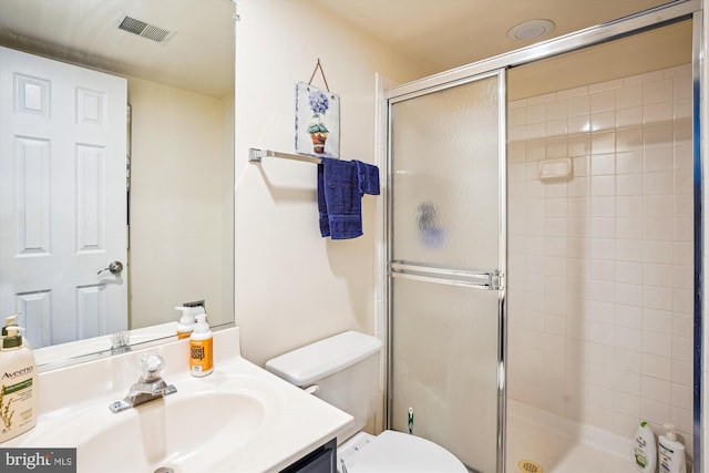 full bathroom with toilet, visible vents, vanity, and a stall shower