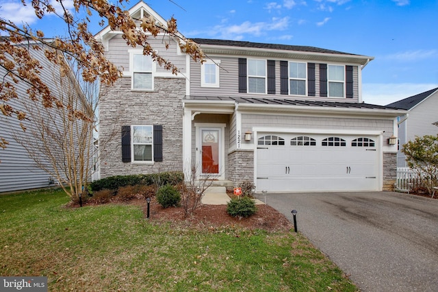 view of front facade with driveway, a front yard, an attached garage, and stone siding