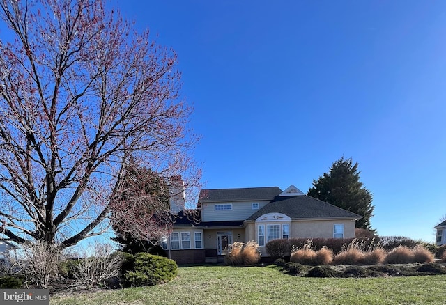 122 Lahinch Ct, Middletown, DE 19709 - view of front facade featuring stucco siding and a front lawn