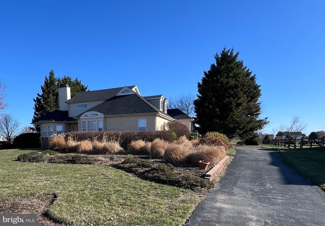 122 Lahinch Ct, Middletown, DE 19709 - view of home's exterior with a yard and a chimney