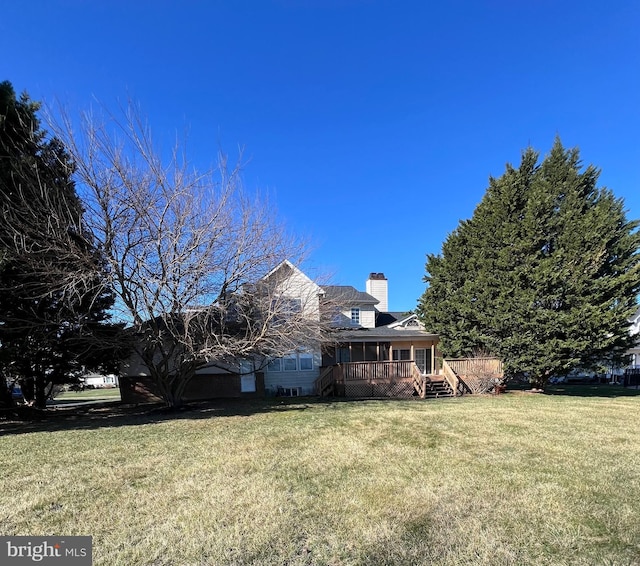 122 Lahinch Ct, Middletown, DE 19709 - exterior space with a chimney, a wooden deck, and a yard